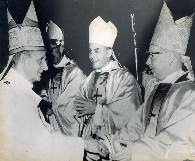 Auxiliary Bishop Bernard McLaughlin is congratulated by his consecrator Pope Paul VI after ceremonies on January 6, 1969 in St. Peter's Basilica in Rome. Auxiliary Bishop Andre Quelen of Angers, France, is seen center.